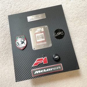Assorted McLaren F1 badges / switch mounted as a carbon effect display