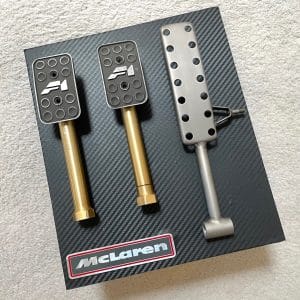 McLaren F1 titanium pedal set mounted on carbon display with front badge