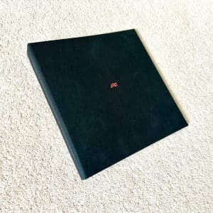 McLaren F1 road car service folder with embedded enamel badge