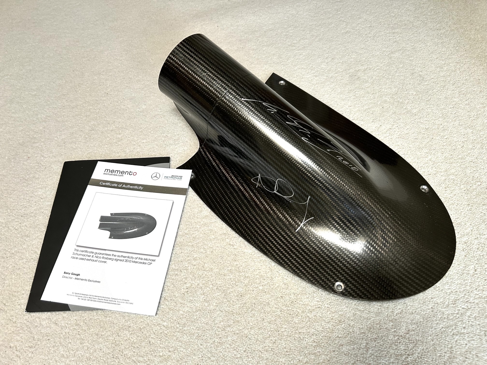 2010 AMG Mercedes GP carbon exhaust shield signed by Michael Schumacher and Nico Rosberg with team COA